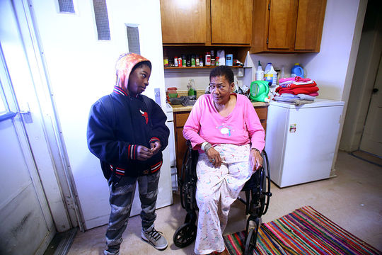 Trevion Foster waits in Jackie Peden's kitchen for the school bus on Feb. 26, 2016. Ms. Jackie, as the kids know her, always has a few motherly words of advice or a treat for the kids. (Tim Bath | Kokomo Tribune)